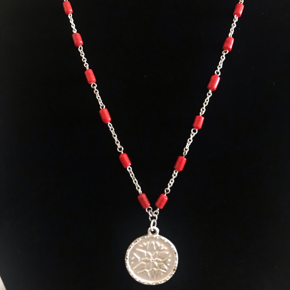 Long beaded necklace with pendent.